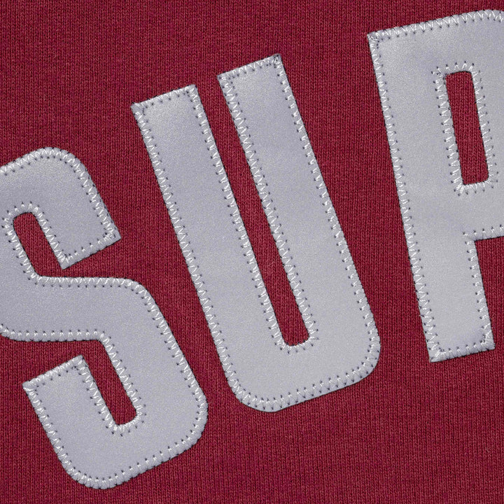 Close-up of the stitched applique arc letters on cardinal fleece
