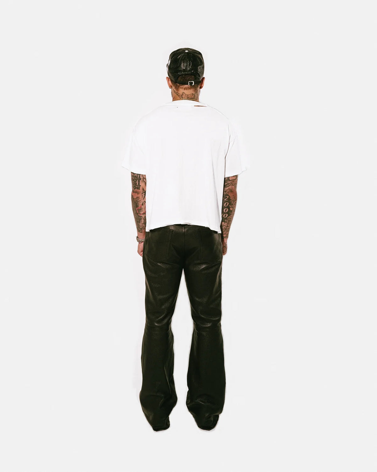 Back view of a model wearing the ivory Bottega Desires ABC Desires T-shirt, showing the plain unprinted back