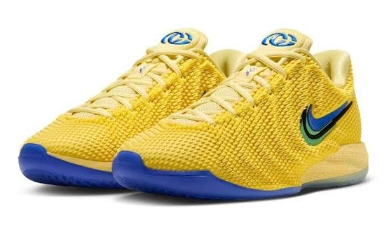 Pair of yellow Nike basketball lows angled front with blue tongue badges and blue soles