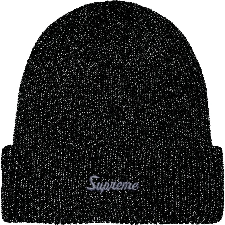 The same black beanie photographed under flash with the reflective yarn lit up