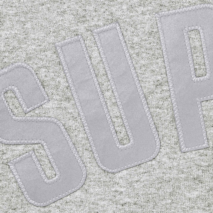Close-up of the stitched applique arc letters on heather grey fleece