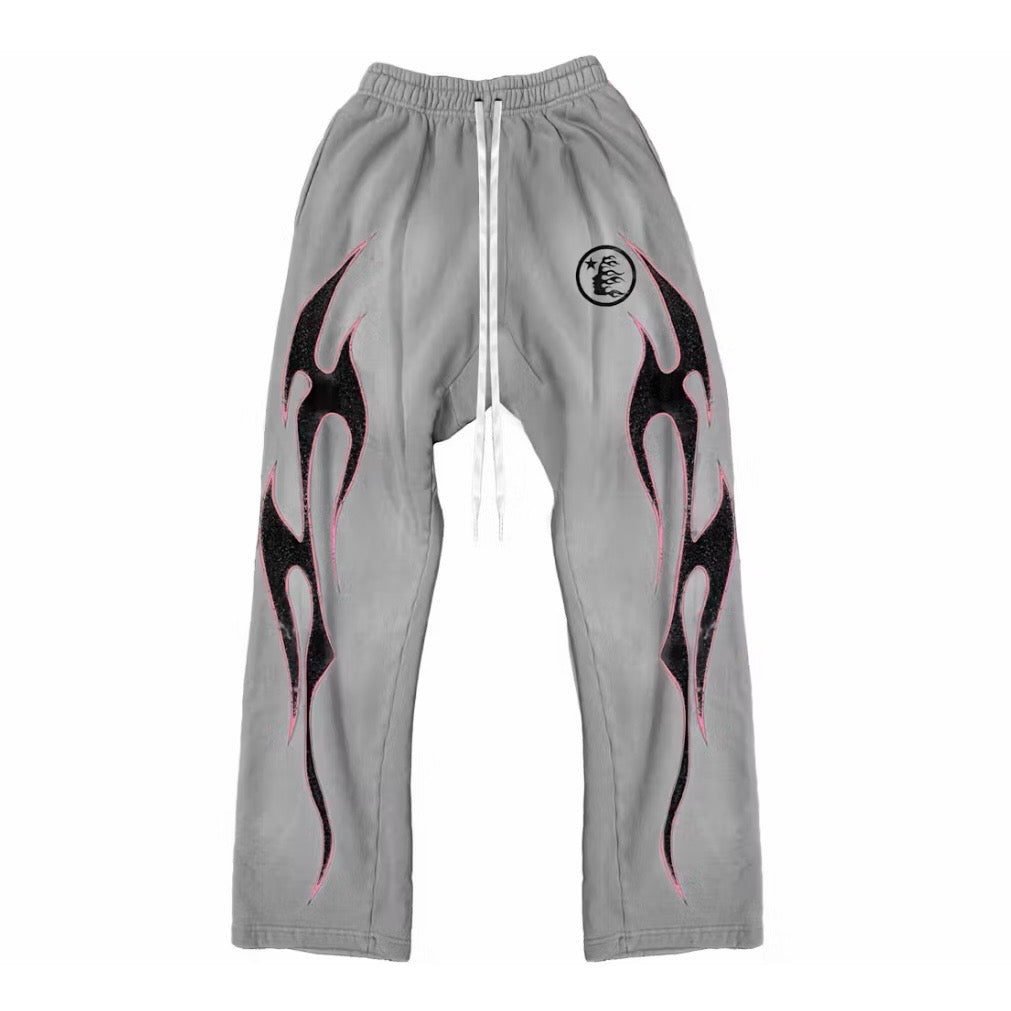 Hellstar Grey Flame Sweatpants front with black pink-outlined tribal flames and a circular seal