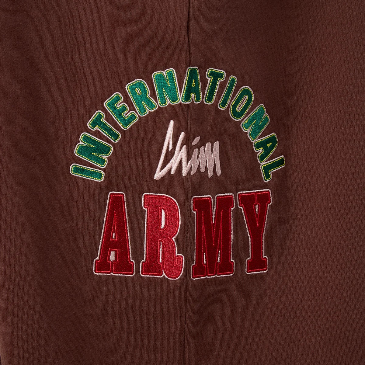 HMDD Brown International Sweats close-up of the green, white and red chenille thigh graphic
