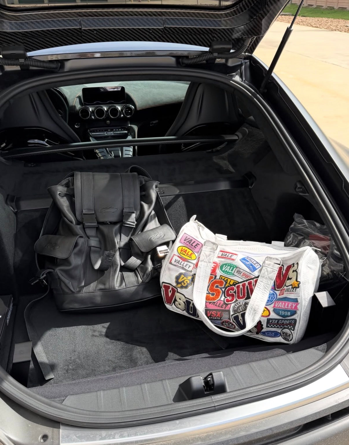 Vale Airport Duffle 1/100, the printed white duffle sitting in an open car boot