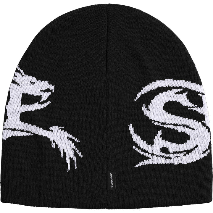 Back of the black Supreme Dragon beanie showing the dragon tail, a large S and a red woven tab