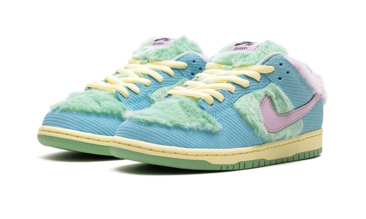 Pair of blue corduroy SB Dunk Lows angled front with mint fur and yellow laces