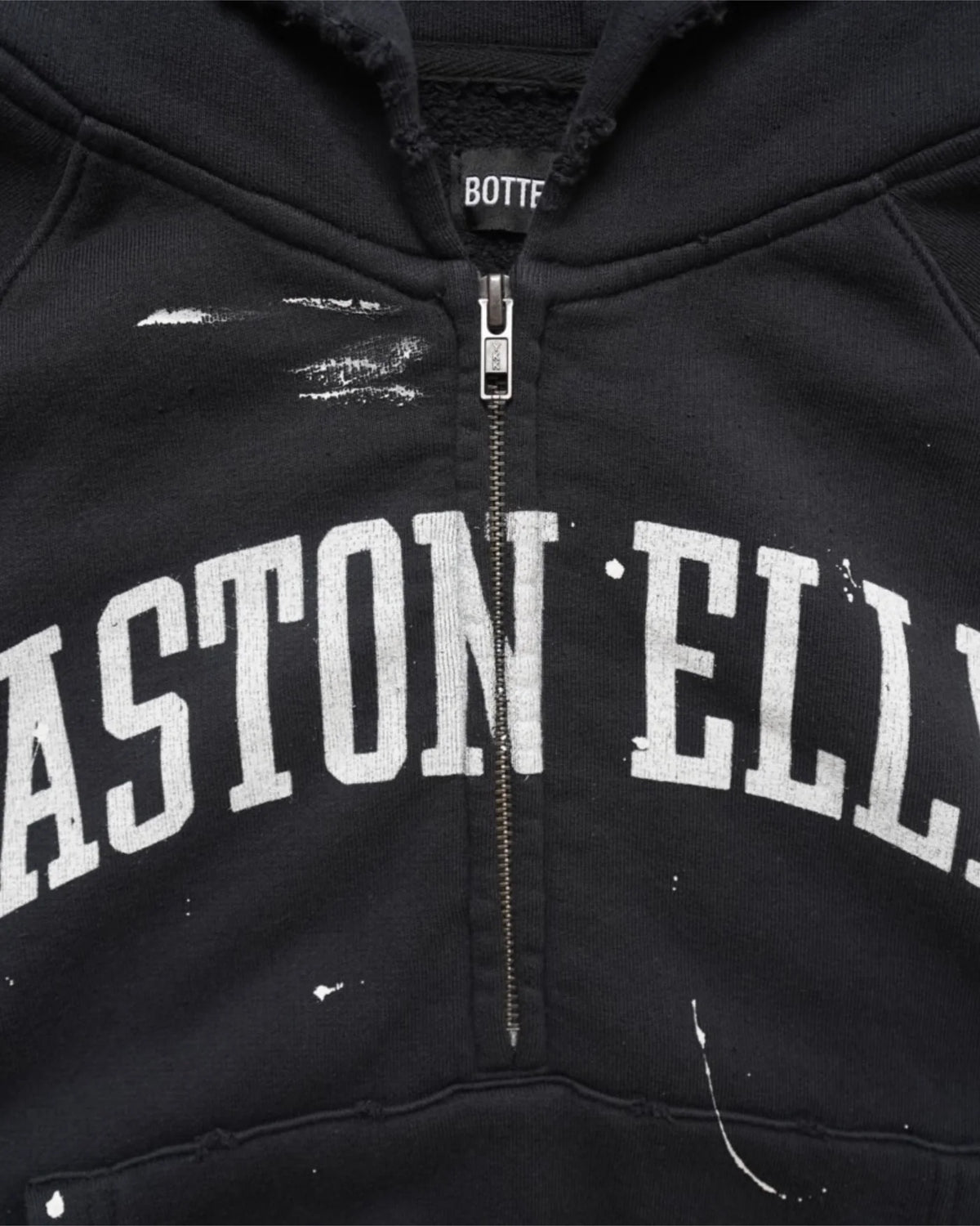 Close-up of the half zip and white EASTON ELLIS collegiate lettering