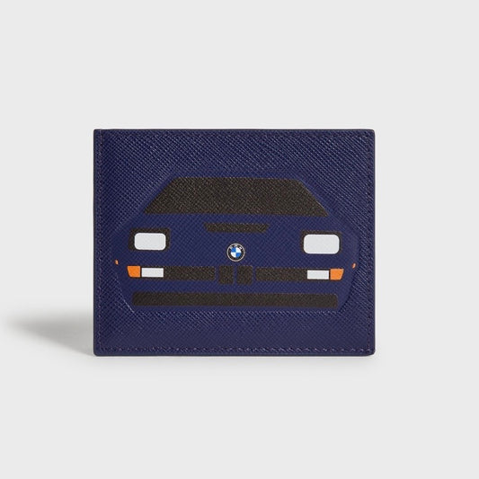 Kith for BMW M1 Techno Violet cardholder in deep violet saffiano leather, printed with the BMW M1 front end - black hood, rectangular headlights, orange indicators and slatted grille