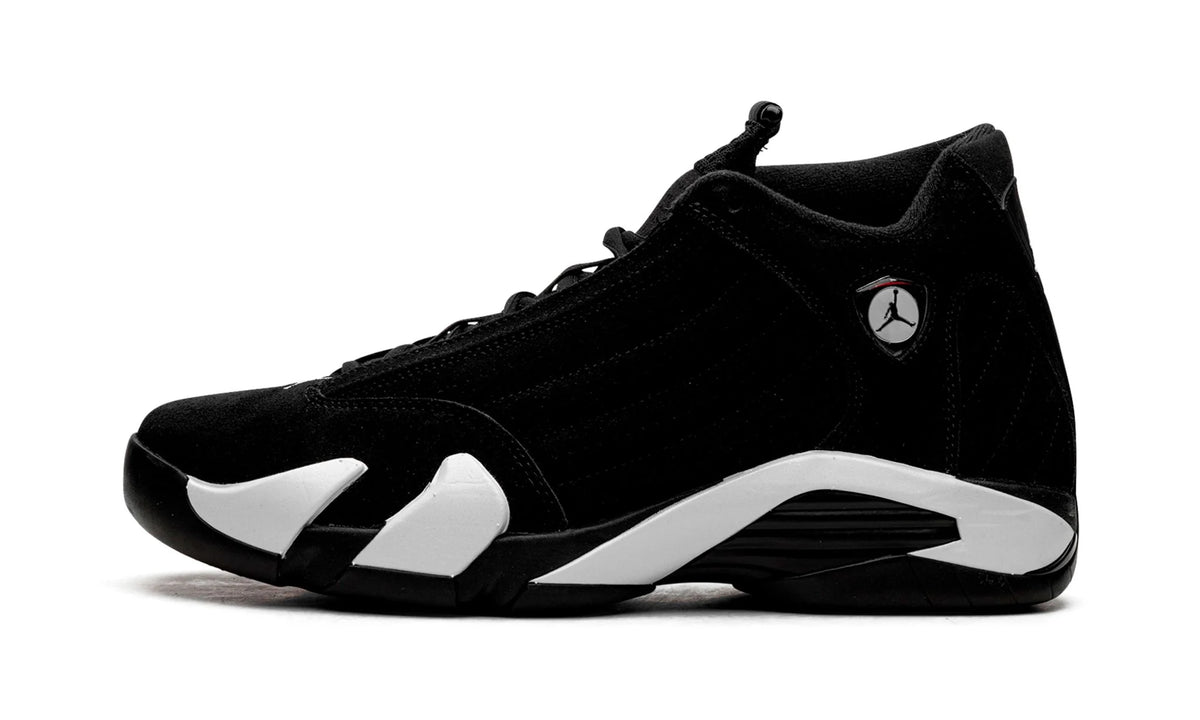 Jordan 14 Black White, side view, black suede upper with a sweeping white midsole and silver Jumpman badge