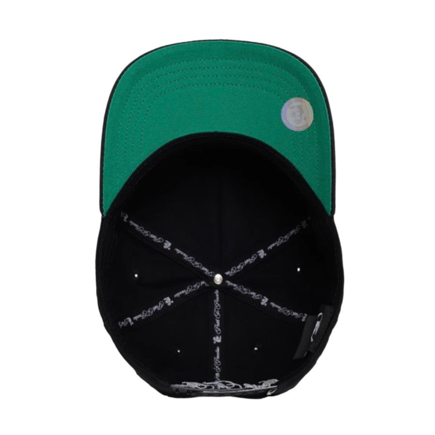 Hellstar Black OG Logo Snapback Hat, underside of the cap showing the green under-brim and taped interior seams
