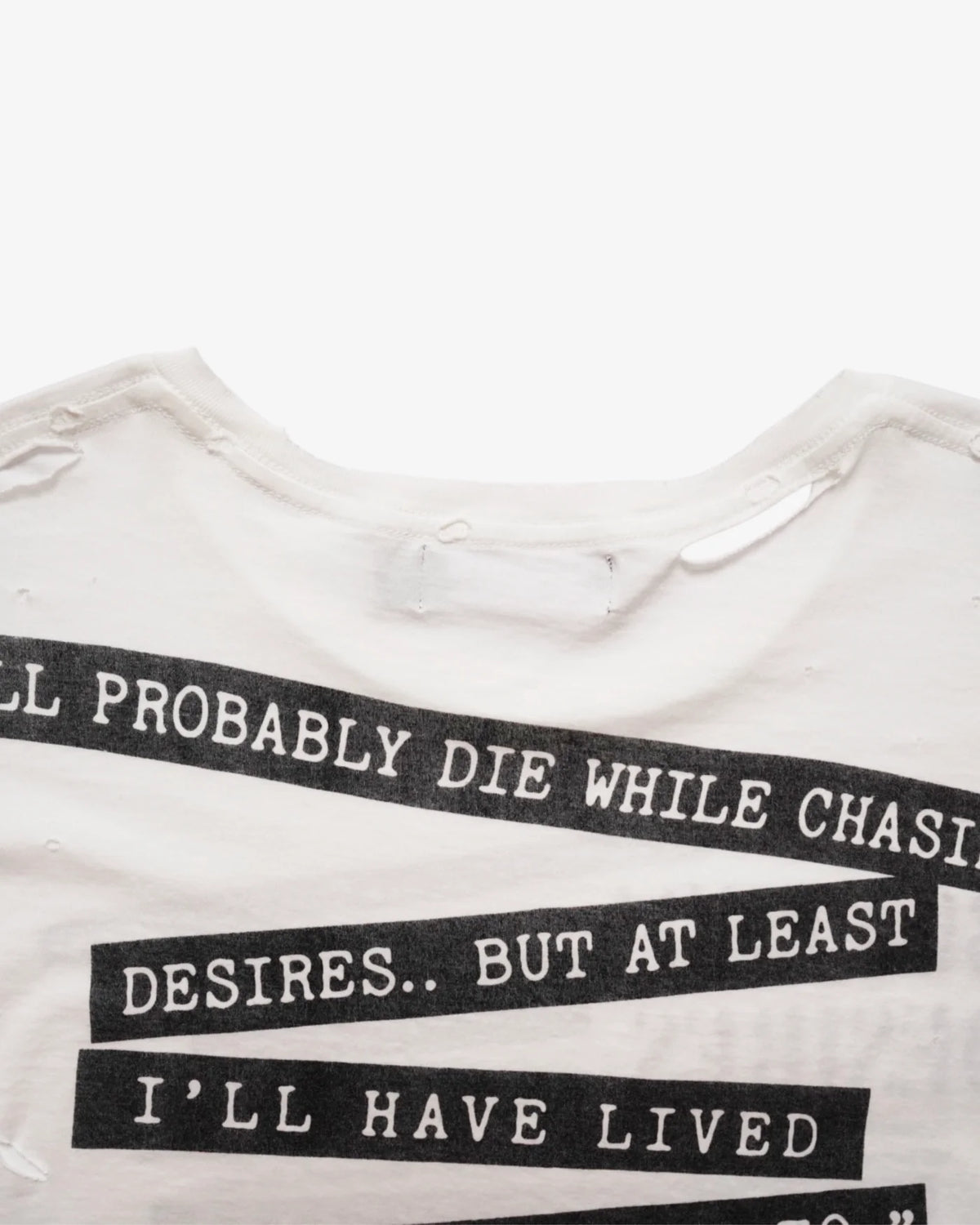 Close-up of the typewriter-style quote strips on the back of the Interview tee