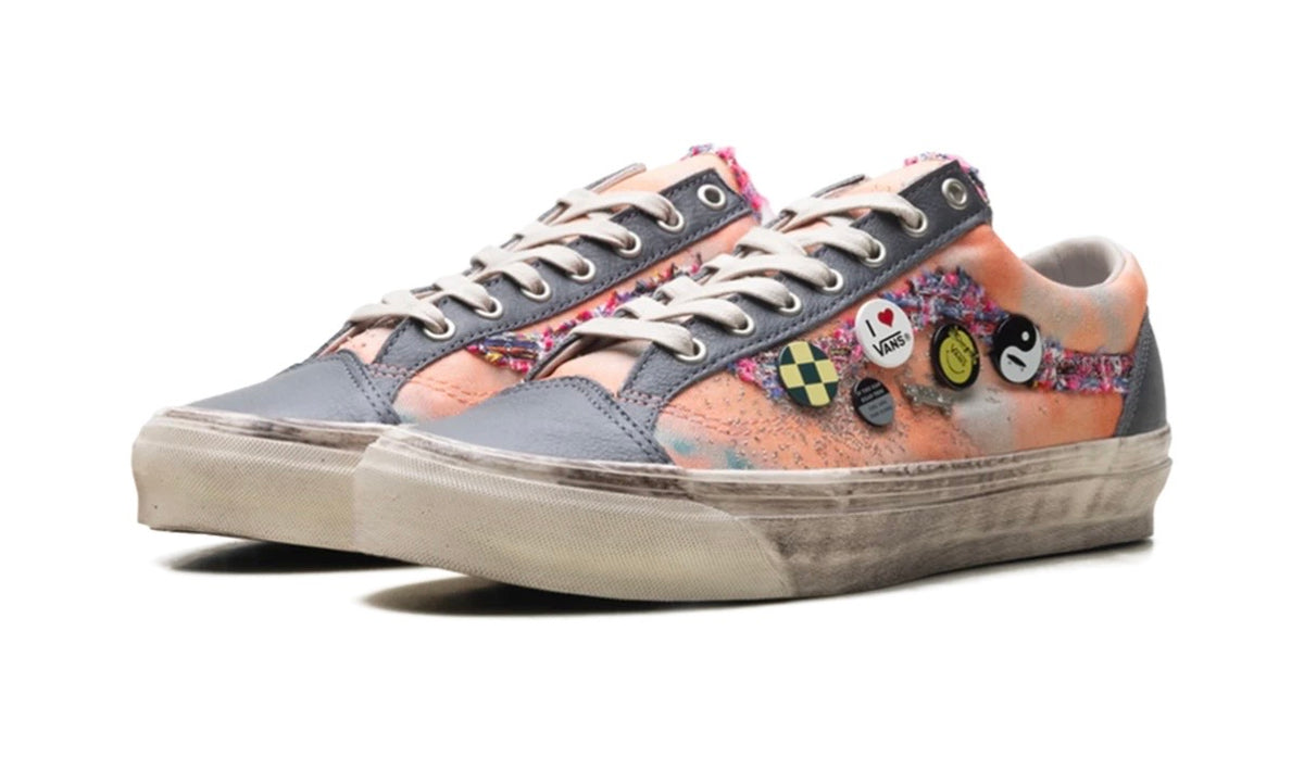 Pair of peach Vans Old Skool angled front three-quarter with pins and tweed trim