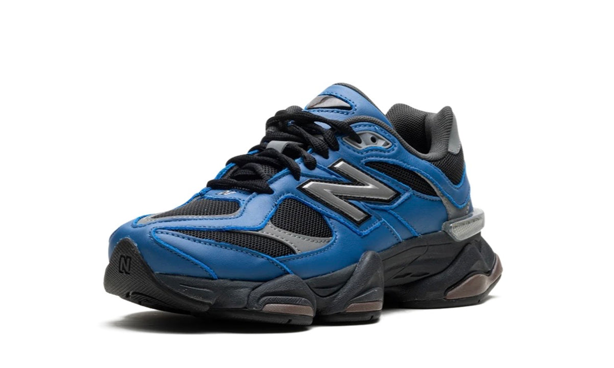New Balance 9060 Dark Royal Brown, angled front view of the blue and black upper