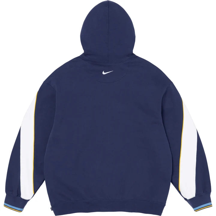 Back of the navy Supreme x Nike hoodie with a small Swoosh below the hood and white sleeve panels