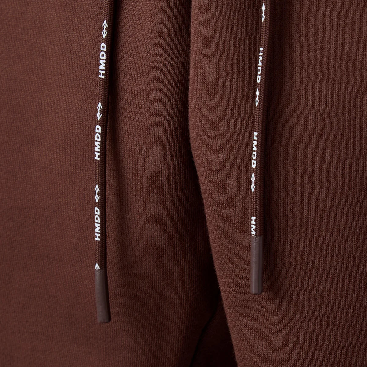 HMDD Brown International Sweats close-up of the drawcord printed with HMDD