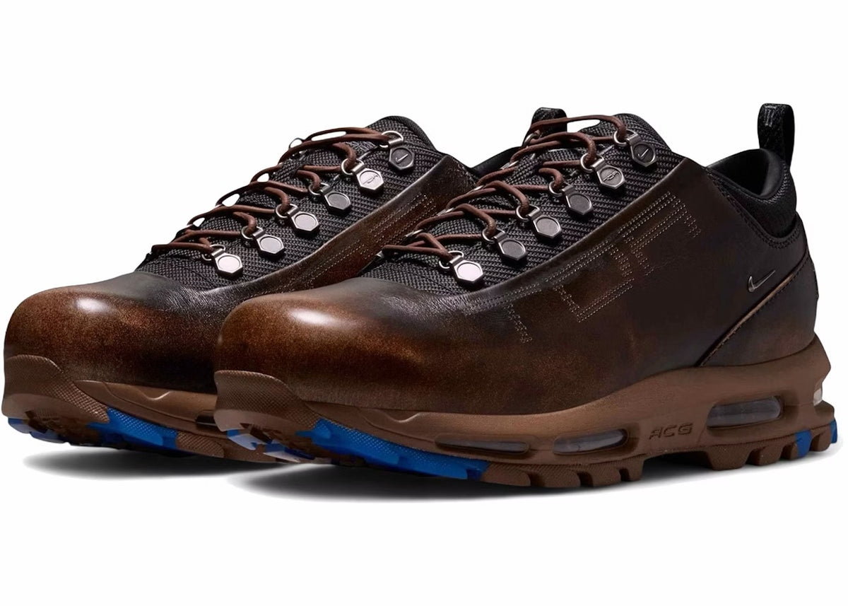 Pair of brown leather Nike Air Max Goadome lows angled front three-quarter on white