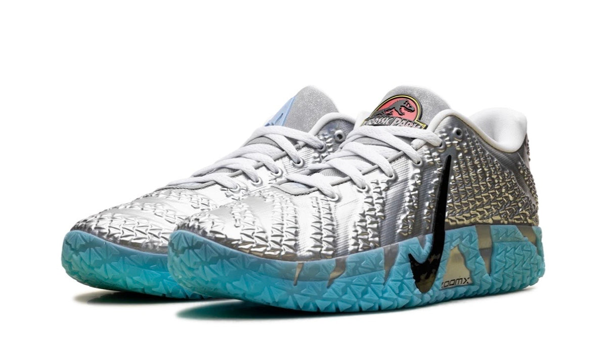 Pair of silver Nike Ja 3 angled front showing Jurassic Park tongue roundels
