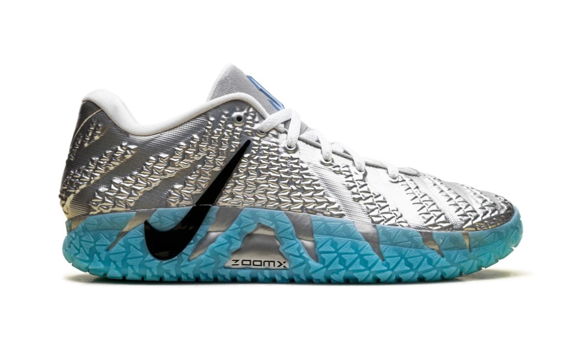 Medial side of silver Nike Ja 3 with black Swoosh and aqua ZoomX midsole