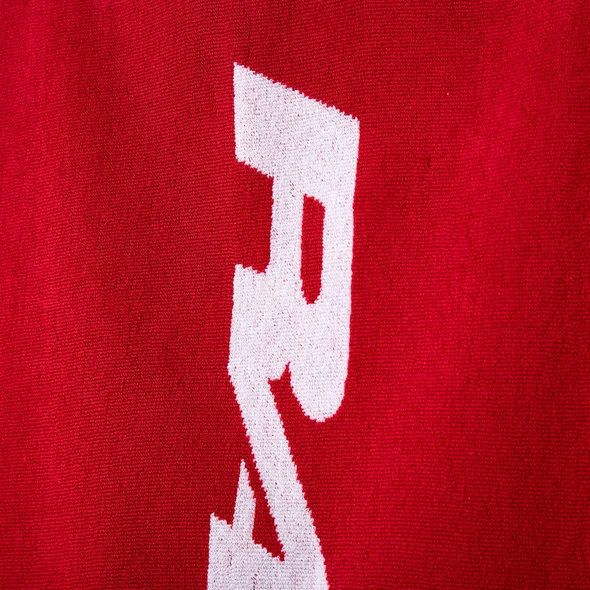 GV Gallery Red Beach Towel, close-up of the white Raspberry lettering woven into red terry