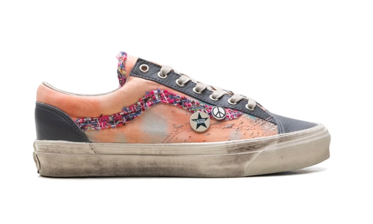 Side profile of peach Vans Old Skool showing star pin, peace pin and frayed tweed