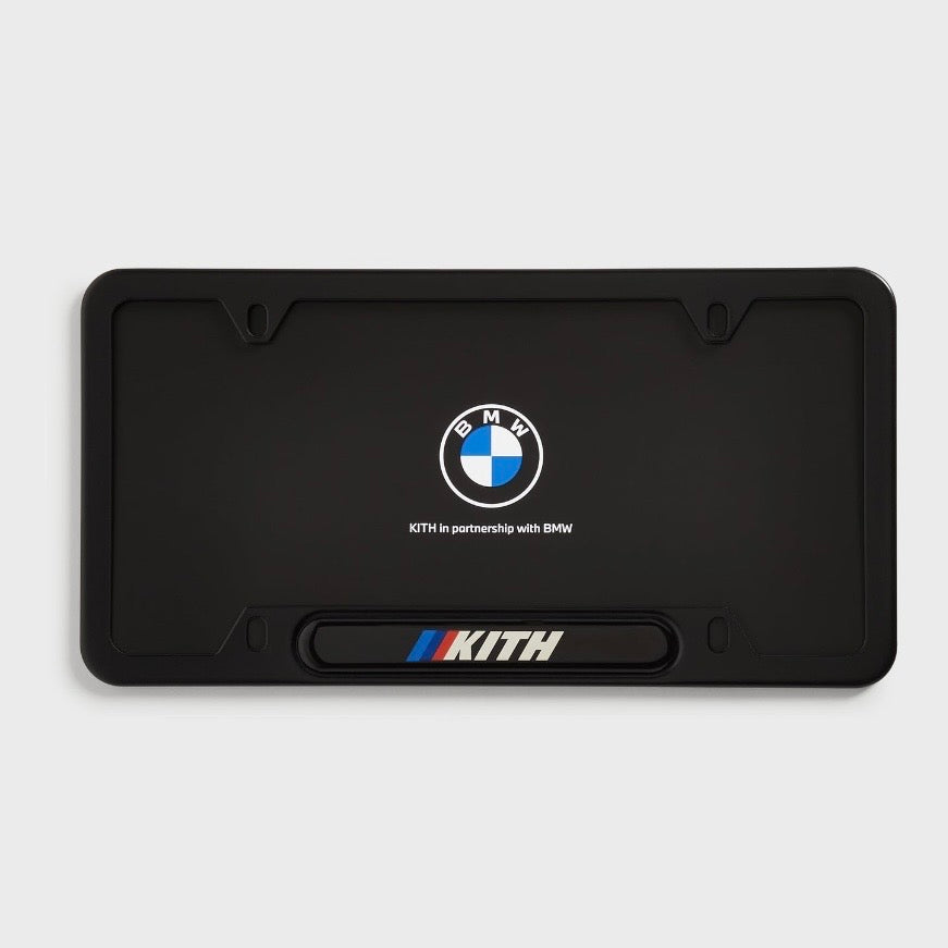 Kith BMW Black License Plate Holder, the black frame fitted around a black plate showing the BMW roundel and Kith bar