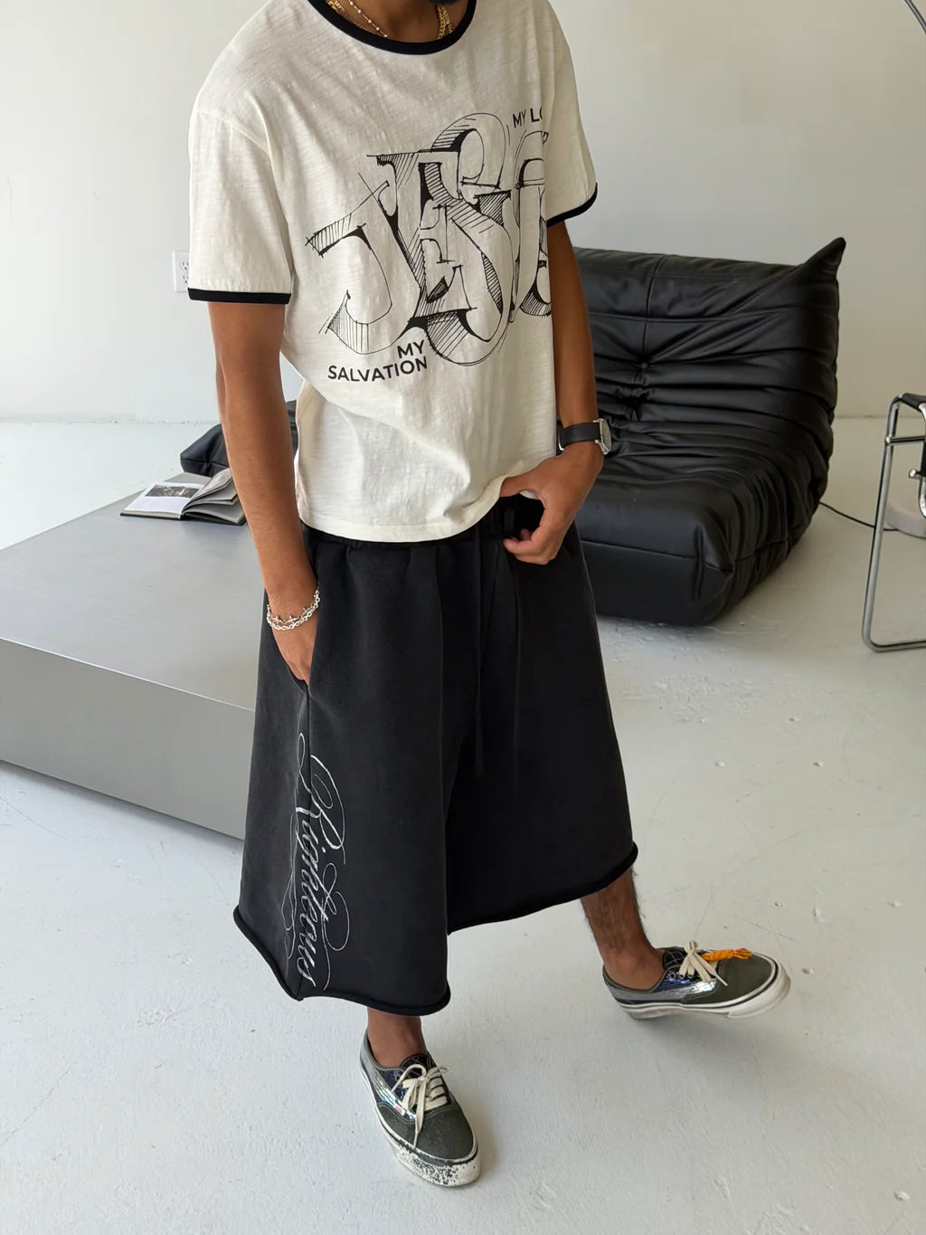 We Are Righteous My Salvation Ringer Tee worn with black baggy shorts and sneakers