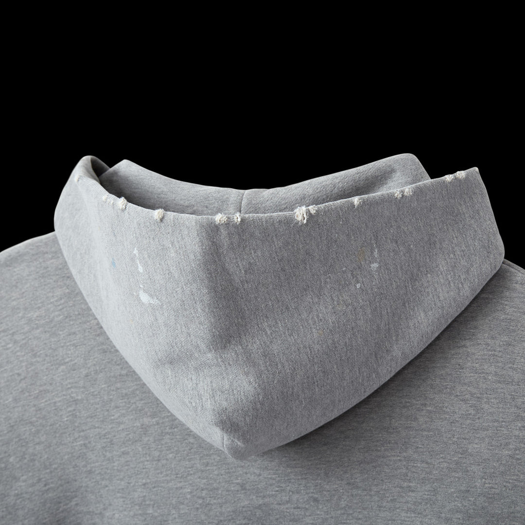 Close-up of the hoodie's deep hood and shoulder with white paint splatters