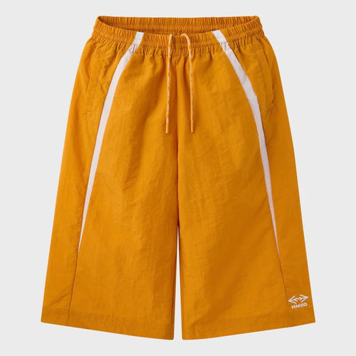 HMDD Gold Juggernaut 3/4 Shorts, orange nylon long shorts with a white side stripe, drawcord waist and logo above the hem