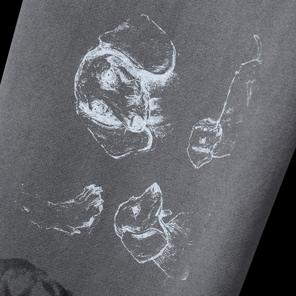 Close-up of loose white line-art sketches screen printed on the grey fabric