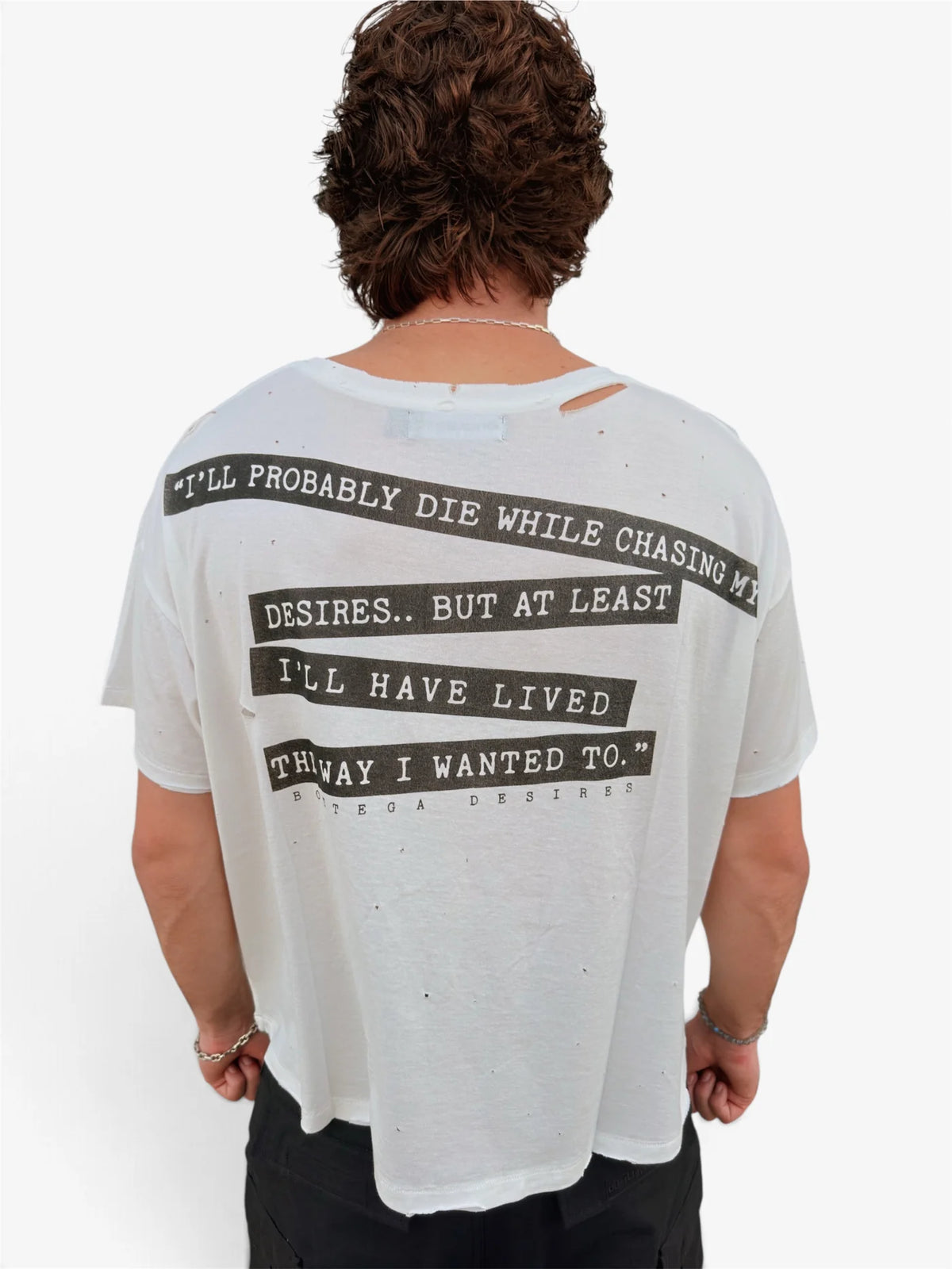 Model wearing the Interview tee, close back view of the quote print and neckline distressing