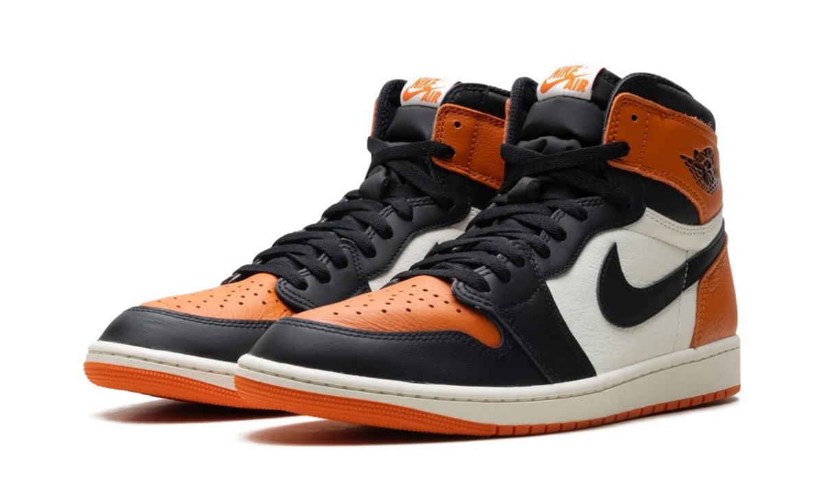 Pair of Air Jordan 1 High Shattered Backboard from the front, black laces and orange toe boxes