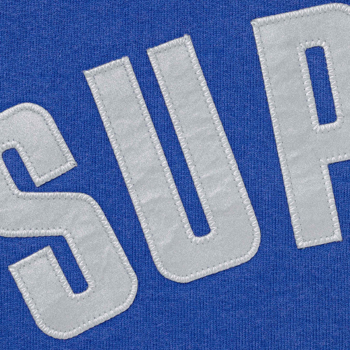 Close-up of the stitched applique arc letters on royal blue fleece