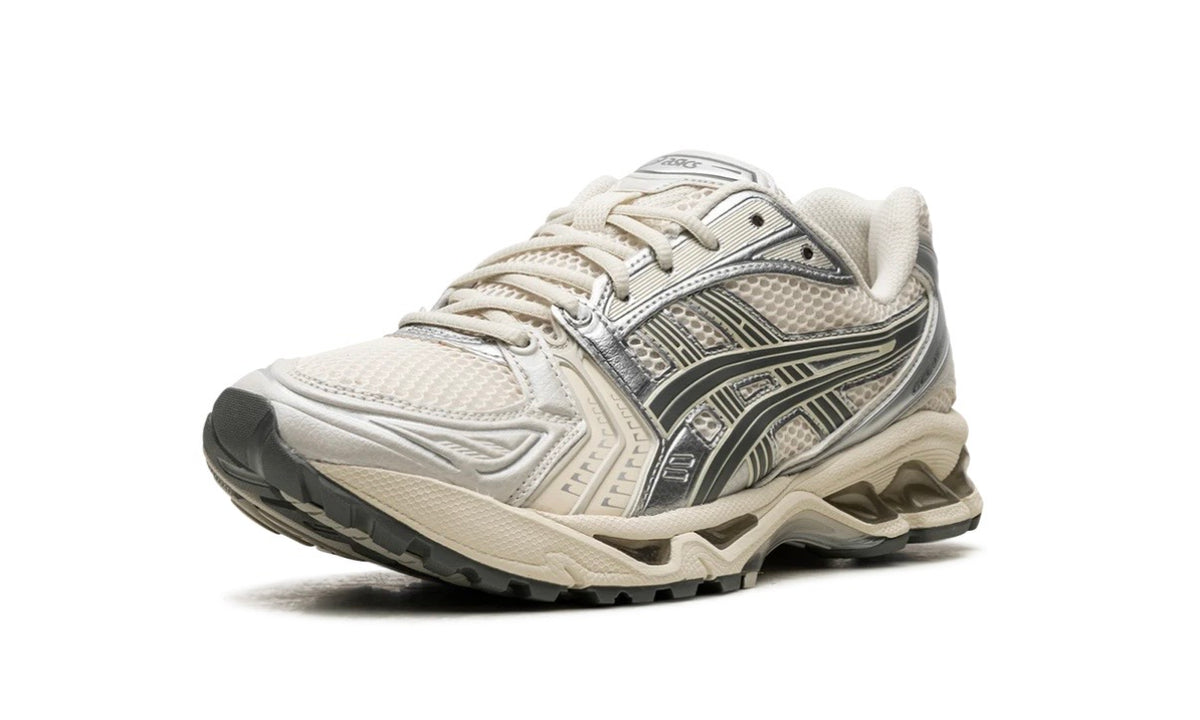Asics Gel-Kayano 14 Birch Dark Pewter, front three-quarter view of the cream mesh toe and silver stripes