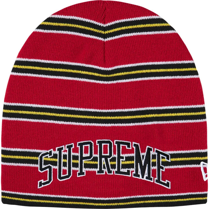 Supreme New Era striped beanie in red with black, yellow and white stripes, arched black SUPREME lettering and a New Era flag