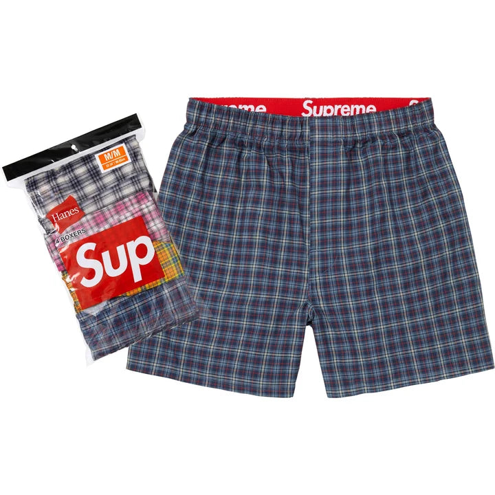 Supreme Multicolor Plaid Boxers shown flat in navy plaid beside the Hanes retail packaging