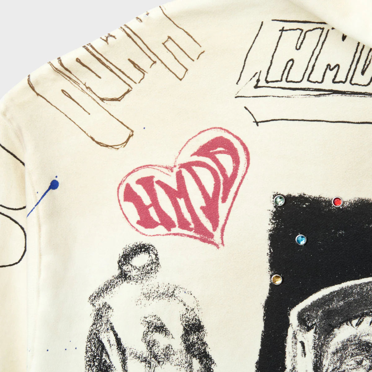 HMDD Sketch Hoodie, detail of the pink HMDD heart graphic beside charcoal figure sketches on cream fleece