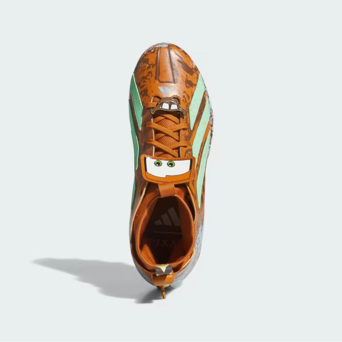 Adidas Pixar Cars Adizero Impact II cleat top-down — Mater's eyes and buck teeth on the lace cage