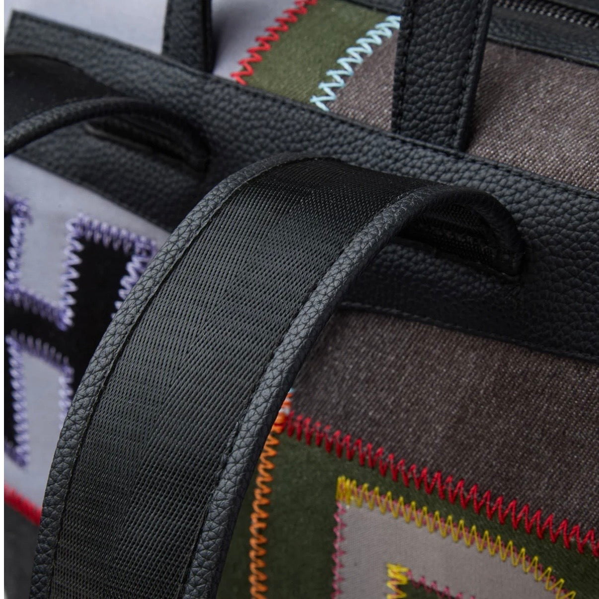 HMDD Hopscotch Box Bag, close-up of the black webbing strap running across the stitched patchwork panels