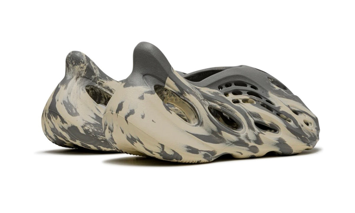 Adidas Yeezy Foam Runner MXT Moon Gray, rear three-quarter view of the pair showing the swirled heel