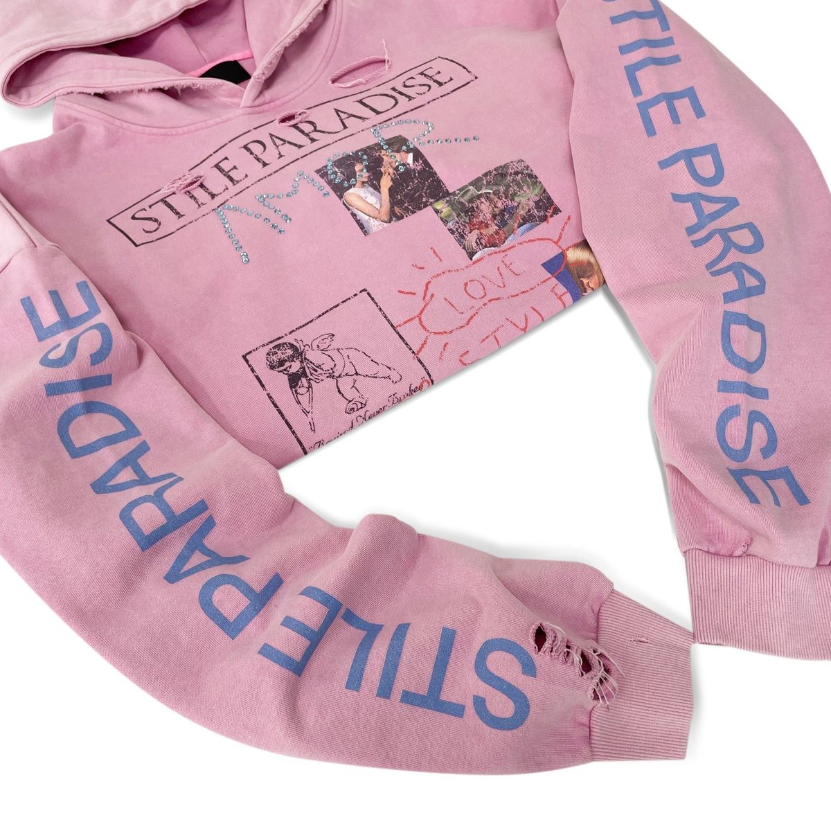 Pink Stile Paradise hoodie laid out showing the blue STILE PARADISE sleeve prints and distressed cuffs