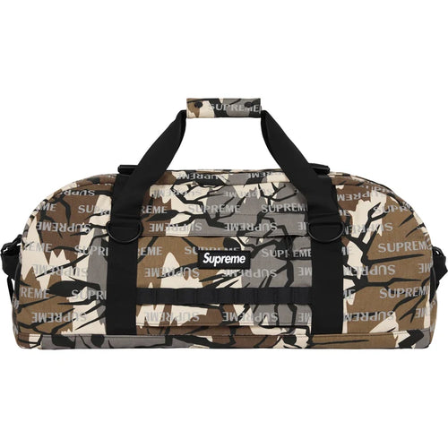 Supreme Predator Camo Large Duffle Bag FW26, side view in brown and tan tree camouflage with webbing daisy-chain loops and the Supreme box logo patch