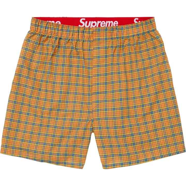 Supreme Multicolor Plaid Boxers flat lay in orange and teal plaid with the red Supreme waistband