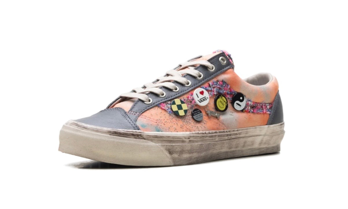 Side profile of peach and grey Vans Old Skool showing tweed trim and four enamel pins