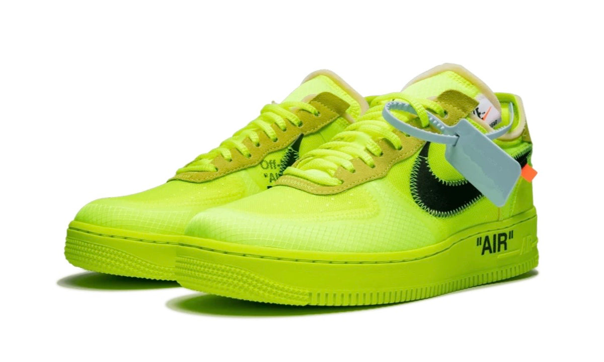 Nike Air Force 1 Low Off-White Volt pair, front three-quarter — medial stencil text and exposed cream foam tongue