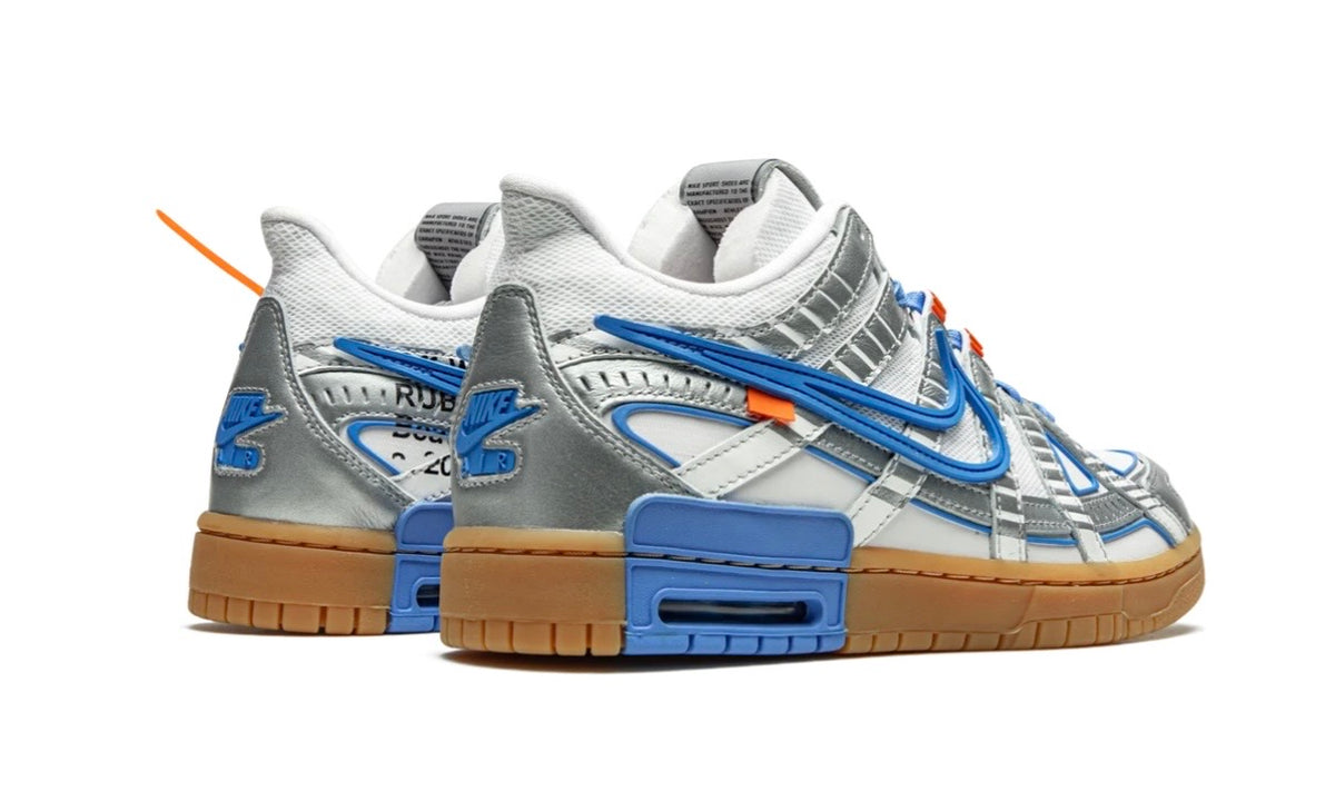 Pair of Off-White x Nike Air Rubber Dunk UNC from the rear, blue heel blocks on gum soles