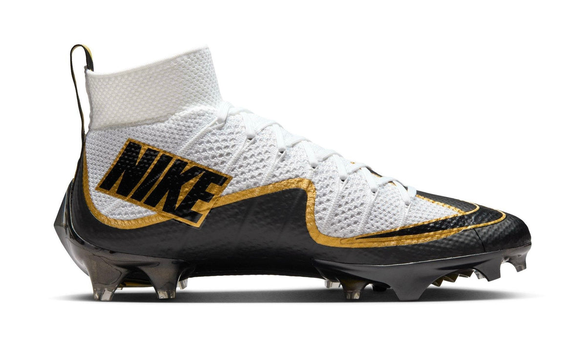 Nike Vapor Edge 360 Untouchable white, gold and black cleat, medial side with large NIKE lettering