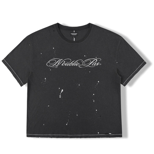 Front of the N'oublie Pas Washed Black Signature T-shirt with N'oublie Pas in fine white script across the chest and paint-fleck distressing