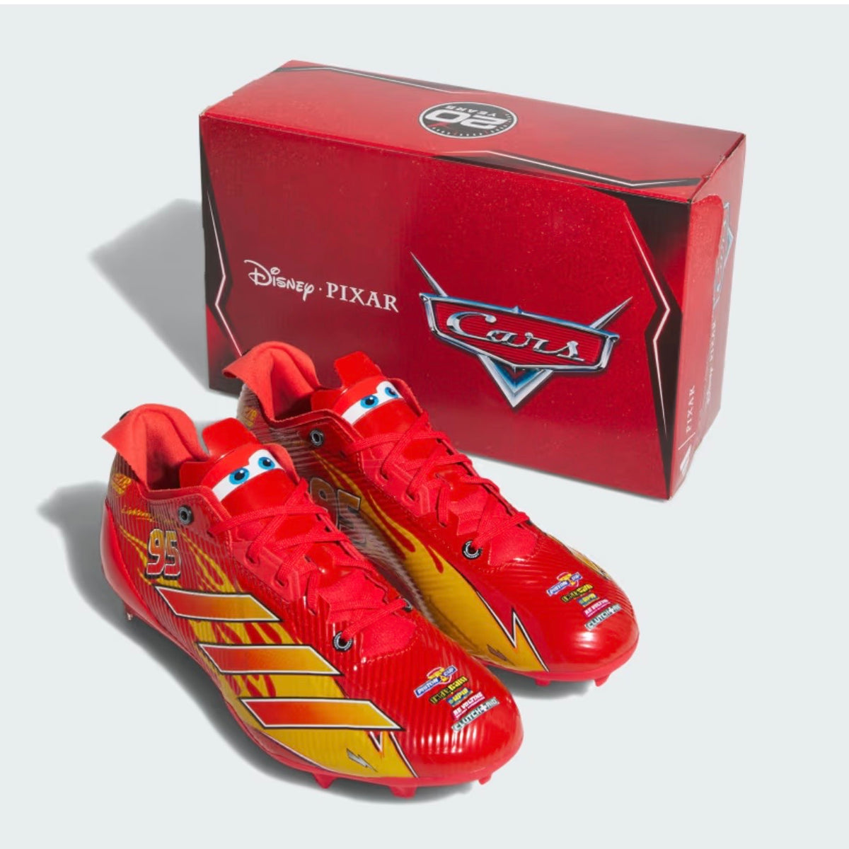 Adidas Pixar Cars Adizero Electric II cleats with the red Disney Pixar Cars box and its 20 YEARS lid badge