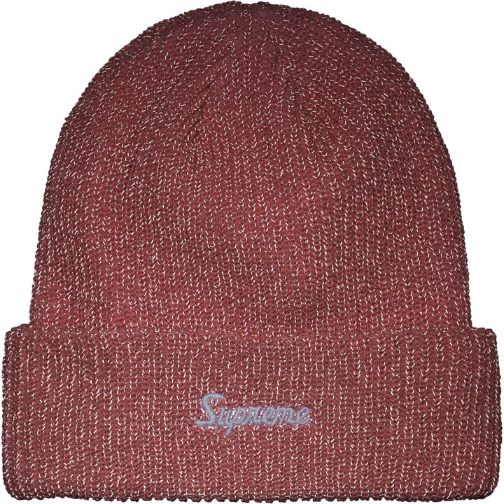 The same pink beanie under flash showing the reflective yarn glowing silver-rose