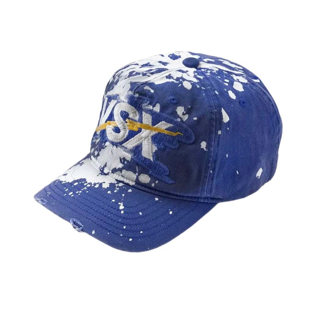 Vale Blue VSX Paint Splatter Hat three-quarter view — splatter across the left panel and distressed curved brim